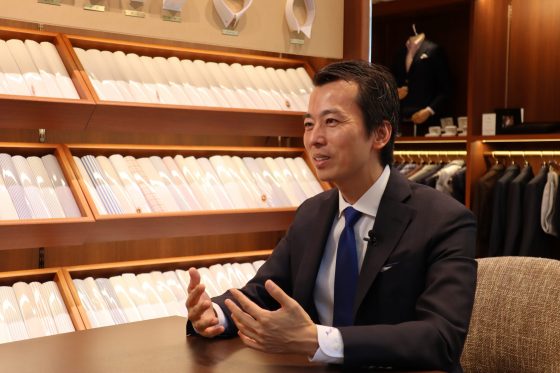 Elegant man sitting in a suite store